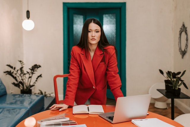 Woman in red suit at her office