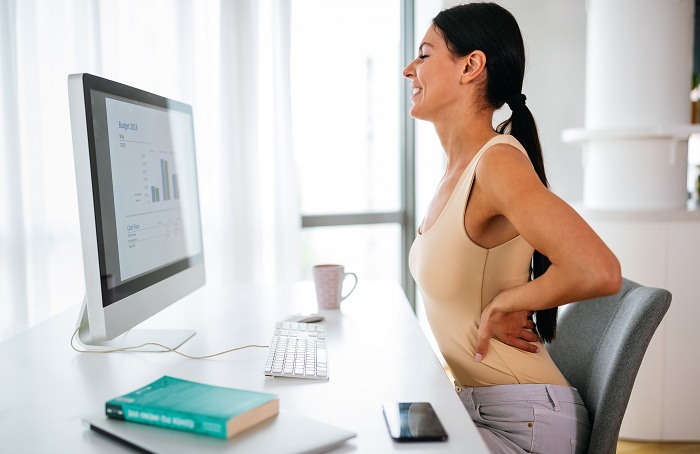 Overworked woman having lower back pain