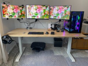 oak standing desk with 3 screens