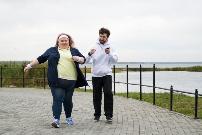 Obese woman trying to work out at the park